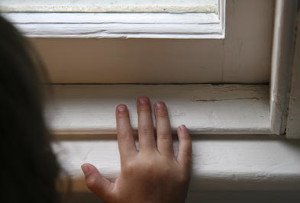 Hand resting on a windowsill