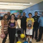 People posing around a bowling lane