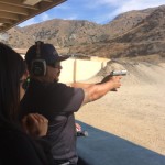 Man shooting a pistol downrange