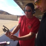 Instructor showing someone how to use a revolver