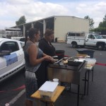 Two people working a grill